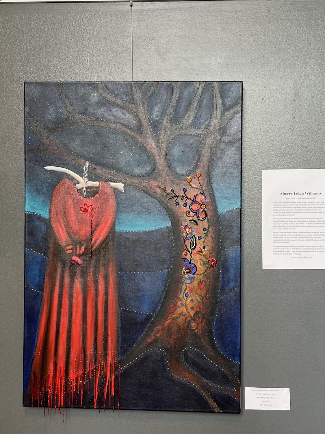 Painting of a red dress on a beaded floral tree against a night sky