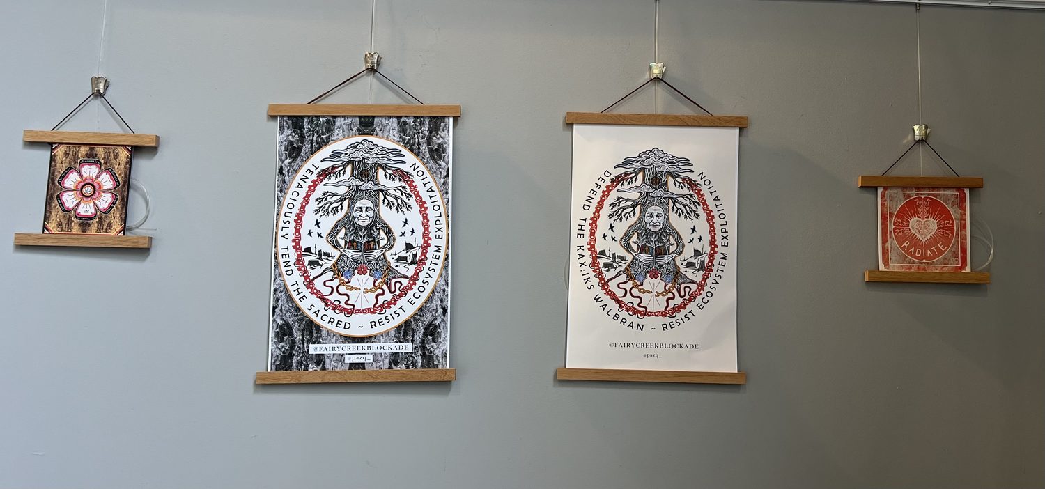 Four hanging prints on a gallery wall